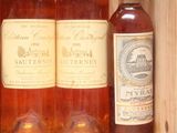 several bottles of wine are in a wooden box on a table