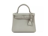a small grey leather handbag on a white background