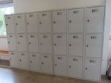 many lockers in a room with a bench in front of them