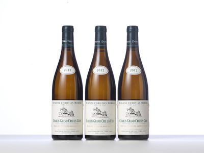 three bottles of wine sitting on top of a table next to each other
