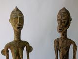 pair of wooden statues of a man and a woman on a table
