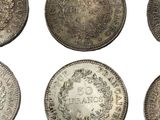 six different types of silver coins on a white background