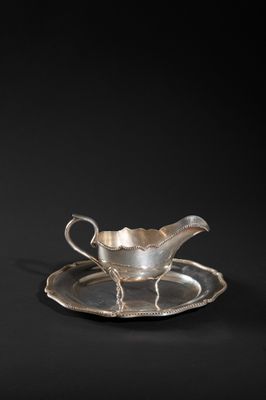 a silver plate with a saucer and saucer on it