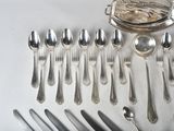 a lot of silver spoons and silverware on the table