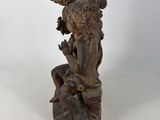 an image of a statue of a boy and a girl on a rock