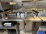 a large stainless steel kitchen with a lot of counter space