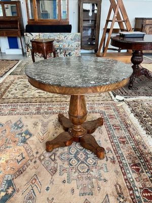 a table with a marble top on a rug in a room