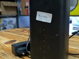 an image of a wireless router on a wooden table