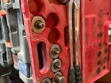 a red tool box with a bunch of tools inside of it