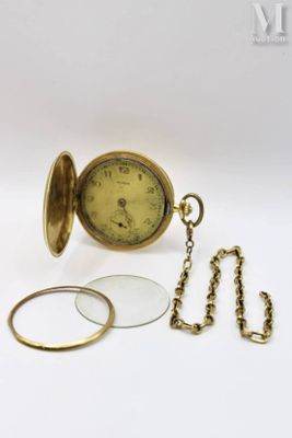 a gold pocket watch with a chain and a magnifying glass
