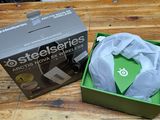 a green box with a white shirt in it on a wooden table