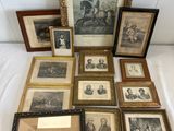 an assortment of framed and unframed prints and drawings on a bed
