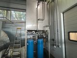 a room with two tanks and a ladder in it