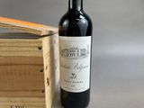 a bottle of wine sitting next to a wooden box