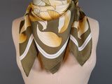 yellow and white floral scarf on a mannequin torso