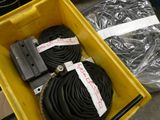 a yellow box with a bunch of black hoses in it