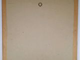 a painting of a circle on a piece of paper hanging on a wall