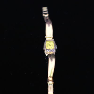 a watch that is sitting on a black surface