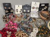 many different types of jewelry on display on a table