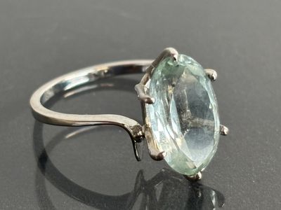 an image of a ring with an aquamarine stone