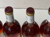 several bottles of wine are lined up on a counter