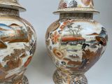 pair of asian vases with asian scenes on them on a white background