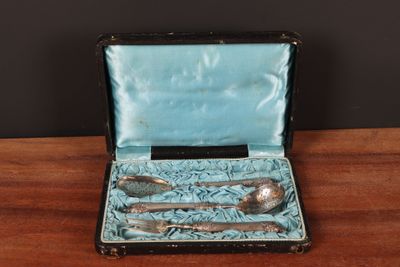a silverware set in a blue case on a table