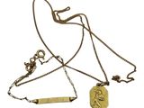 a close up of a necklace with a medal on a chain