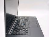 a laptop computer sitting on a table with a keyboard