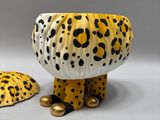 two ceramic animal figurines of leopards and a turtle on a white surface