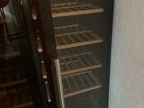 a wine cooler that is next to a wall