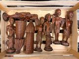 a wooden box with a bunch of carved figurines in it