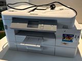 a white printer sitting on top of a white table