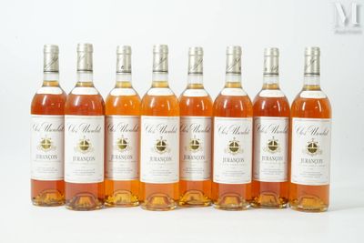 six bottles of wine are lined up in a row on a white surface