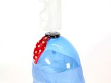 a glass sculpture of a man ' s head with a red bandanna around his neck