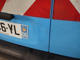 a blue van with a red and white stripe on it