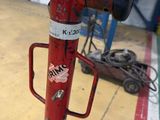 a red fire hydrant with stickers on it in a garage