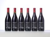 six bottles of red wine lined up in a row