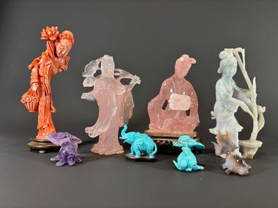 five figurines that are sitting on a black surface