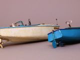 two small boats sitting next to each other on a table