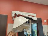 a picture of a hair salon with a mirror and a hair dryer