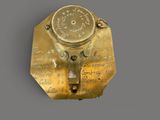 brass plate with writing on it on a gray surface