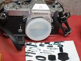 a camera and some other items on a red table