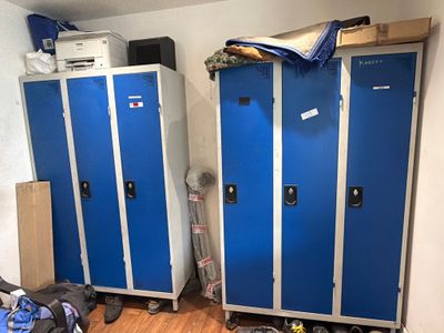 two blue lockers in the corner of a room