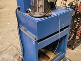 a blue machine that is sitting in a garage