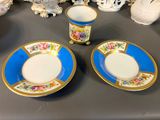 two cups and saucers sitting on a table