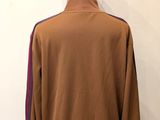 a mannequin mannequin with a brown jacket on a mannequin mannequin