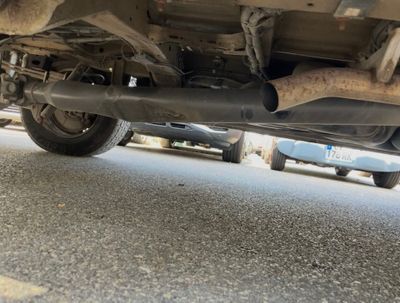 a close up of a car under a vehicle on the street