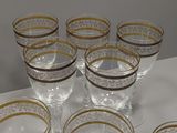 a lot of glasses sitting on a table with gold rims