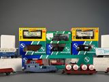 several toy trains are lined up in a row on a gray surface